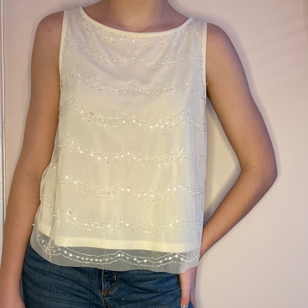 Cream colored tank top with beaded design